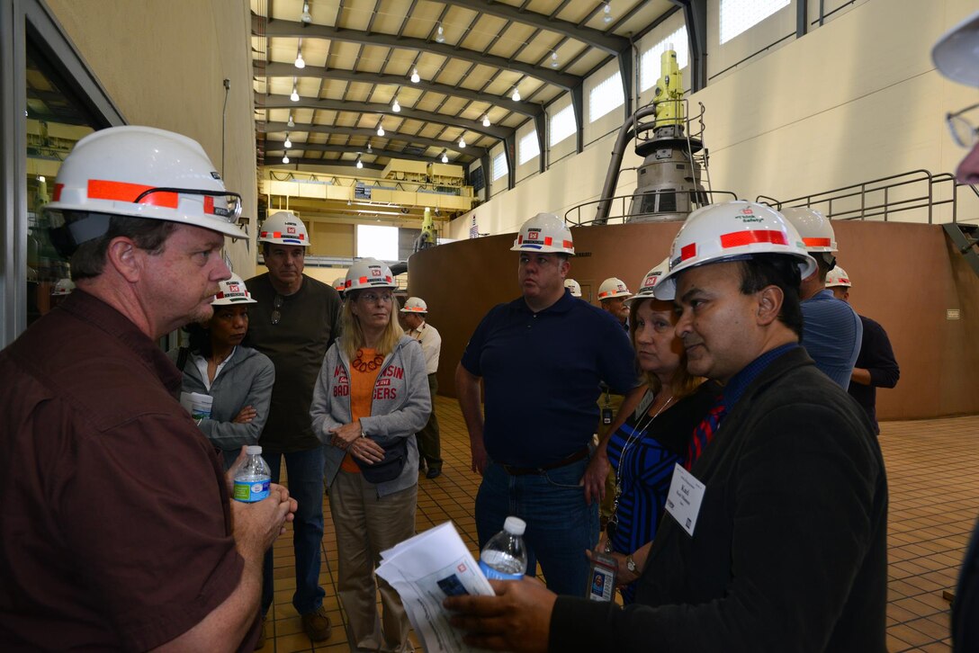 Steven Crawford, a hydropower trainees from the Old Hickory power plant, explains how the control room works to a group from the Federal Utility Partnership Working group during a tour at the Old Hickory Dam in Hendersonville, Tenn., April 23, 2015.
