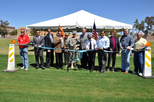 Officials cut the ribbon ceremonially marking the completion of the final phase of the Tucson Drainage Area/Arroyo Chico Multi-use Project at Tucson High School April 16. The $5 million segment was completed in 11 months and will greatly reduce flood risk for more than 1,000 residential, commercial and industrial structures with an assessed value of over $300 million.