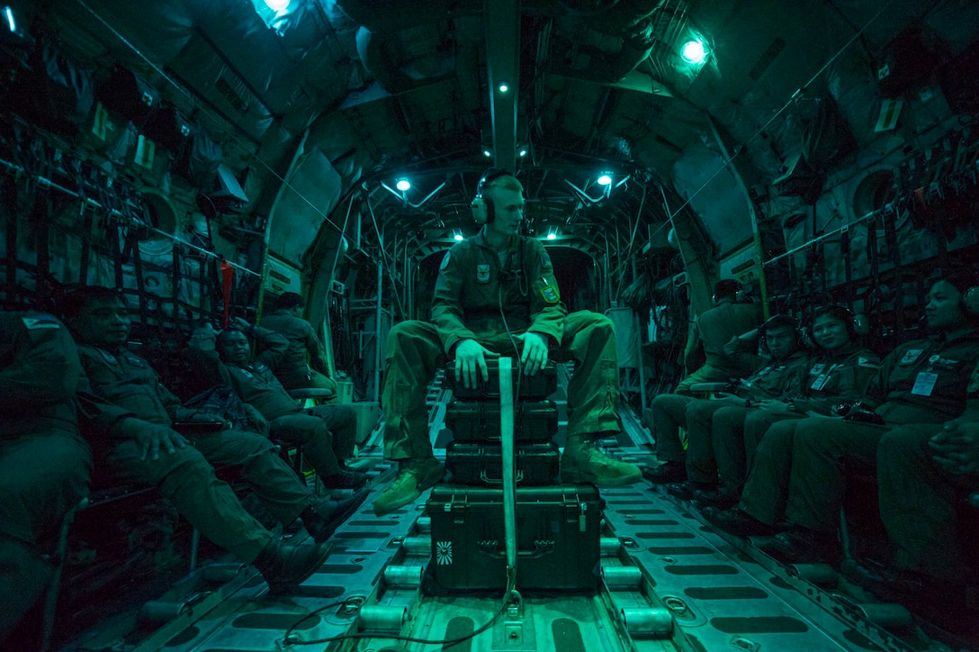 U.S. Air Force Senior Airman Nicholas Oswald, a loadmaster, 374th Operations Support Squadron, Yokota Air Base, Japan, sits with Philippine air force aircrew members during a night flight, April 24, as part of exercise Balikatan 2015. Balikatan is a Filipino term that means "shoulder to shoulder," or "sharing the load together," and characterizes the spirit of the exercise, focusing on Philippine-U.S. partnership and commitment to the Mutual Defense Treaty.