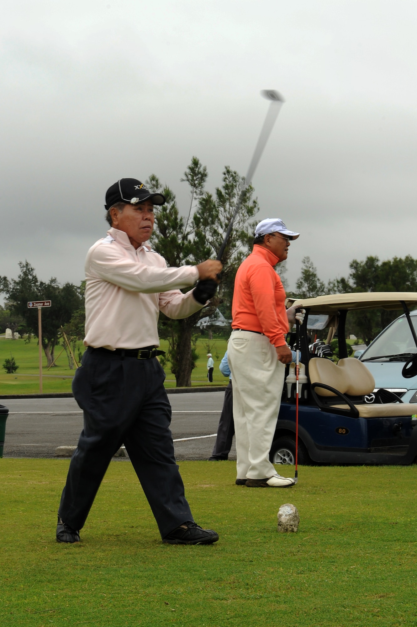 Tetuo Sunagawa, an Urasoe City resident, hits a golf ball toward a prize hole during the Kadena Special Olympics golf tournament fundraiser on Kadena Air Base, Japan, April 29, 2015. The tournament’s prize hole challenged participants to hit their ball onto a specific area of the course in one stroke, earning themselves a set of golf balls of their choosing if they succeeded. (U.S. Air Force photo by Airman 1st Class Zade C. Vadnais)
