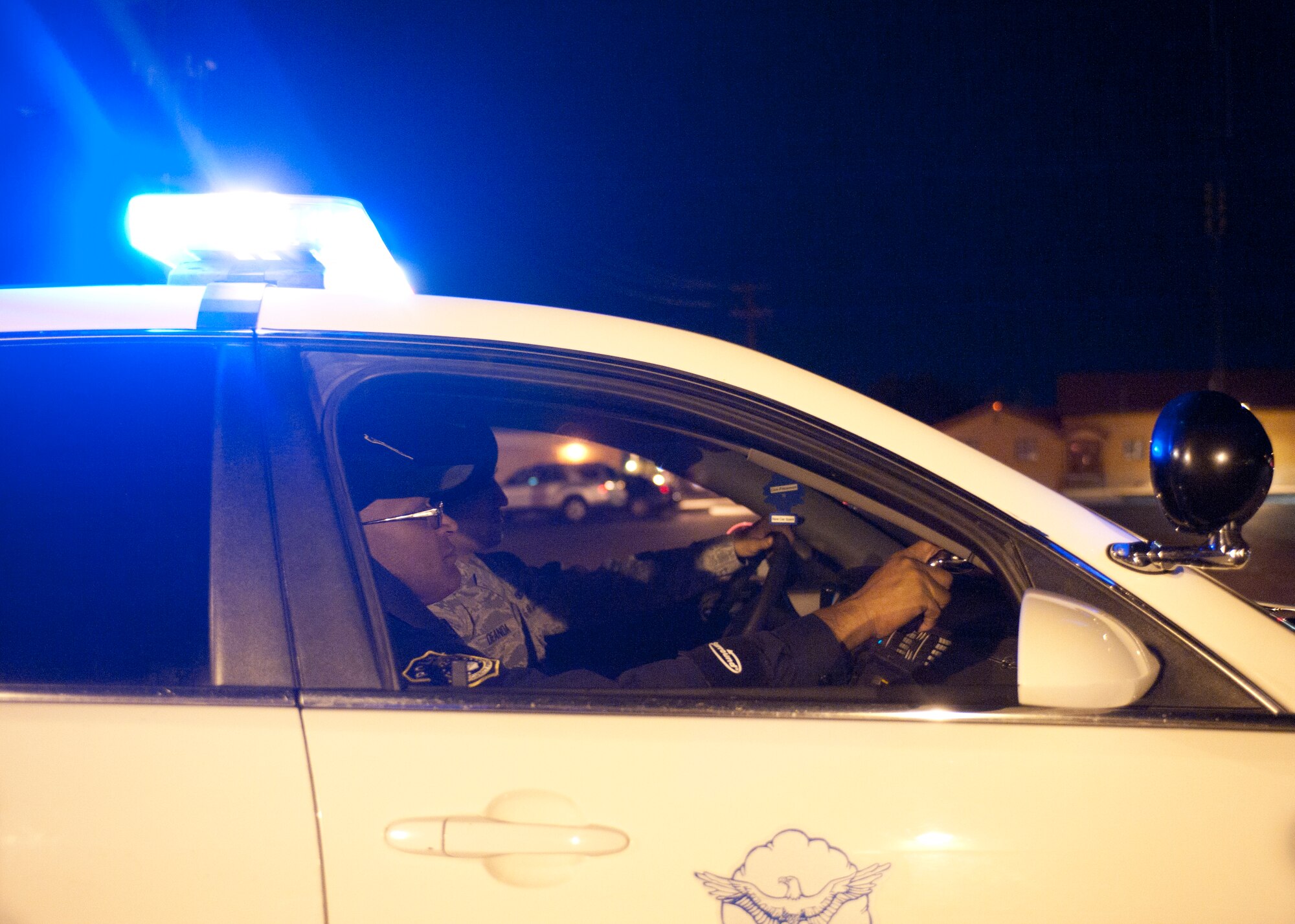 Senior Airman Jiles Deanda and Victor Morales, both 99th Security Forces Squadron patrol leaders, watch over a street on Nellis Air Force Base, Nev., April 27, 2015. The 99th SFS is charged with defending the base and all of its assets 24/7. (U.S. Air Force photo by Staff Sgt. Siuta B. Ika)