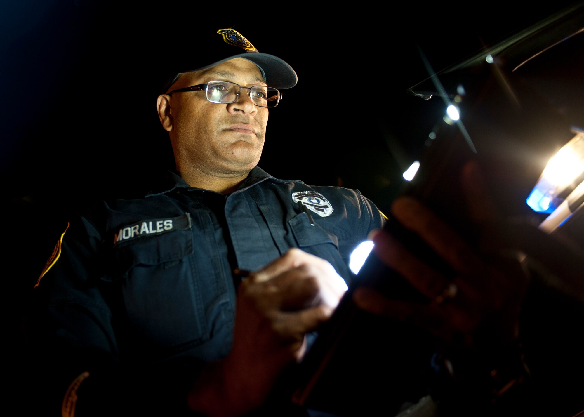Victor Morales, 99th Security Forces Squadron patrol leader, fills out a traffic citation at Nellis Air Force Base, Nev., April 27, 2015. The 99th SFS provides flight line security, police services, antiterrorism and force protection for Nellis and Creech AFBs. (U.S. Air Force photo by Staff Sgt. Siuta B. Ika)
