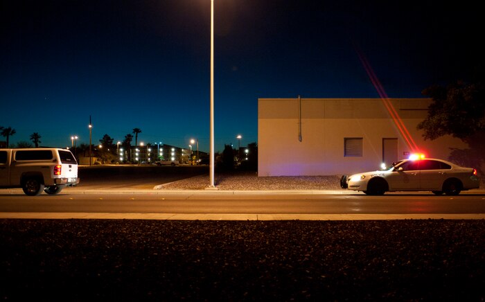 A 99th Security Forces Squadron patrol team pulls over a vehicle at Nellis Air Force Base, Nev., April 27, 2015. The 99th SFS provides flight line security, police services, antiterrorism and force protection for Nellis and Creech AFBs. (U.S. Air Force photo by Staff Sgt. Siuta B. Ika)