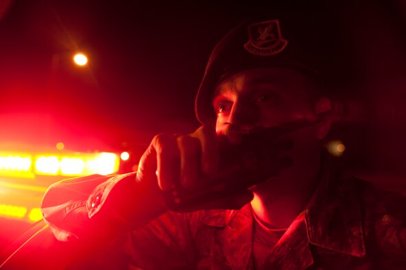 Senior Airman Jiles Deanda, 99th Security Forces Squadron patrol leader, talks on the radio to the Base Defense Operations Center at Nellis Air Force Base, Nev., April 27, 2015. The 99th SFS is charged with defending the base and all of its assets 24/7. (U.S. Air Force photo by Staff Sgt. Siuta B. Ika)