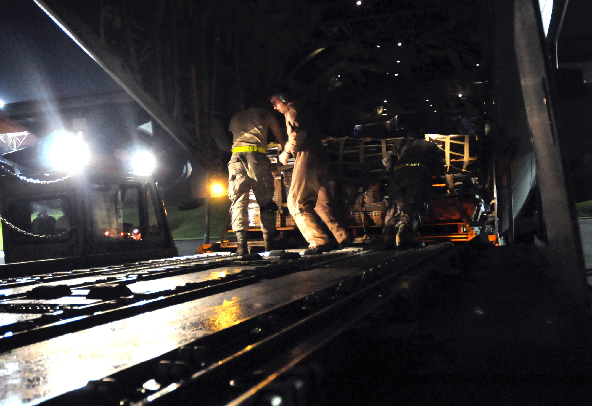 U.S. Air Force and Marine Corps personnel load gear for a U.S. Pacific Command Joint Humanitarian Assistance Survey Team onto a U.S. Marine Corps C-130 at Kadena Air Base, Japan, on April 29, 2015. The survey team is deploying to Nepal to assist earthquake relief efforts. (U.S. Air Force photo by 2nd Lt. Erik Anthony)