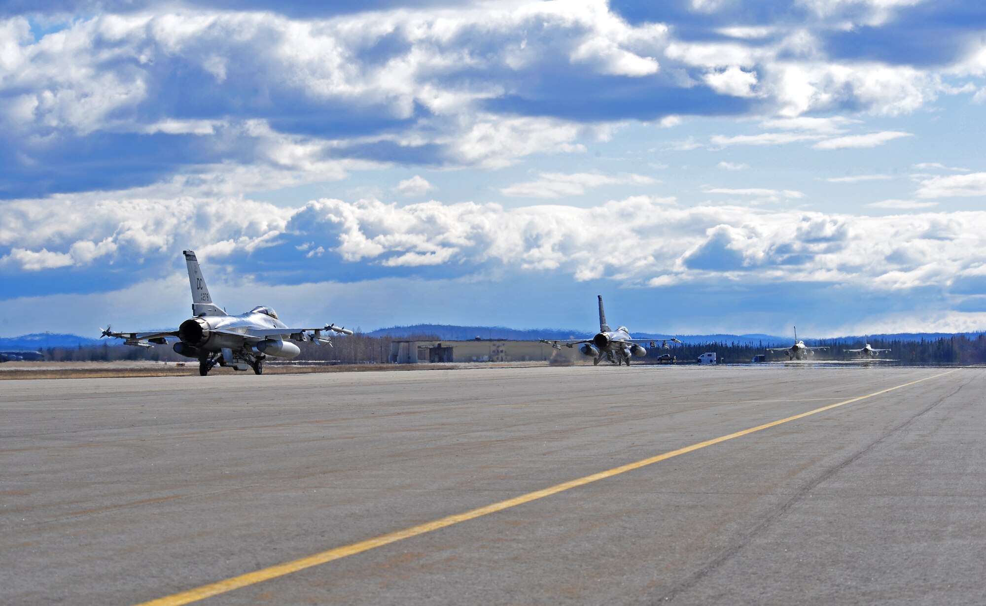 F-16 Fighting Falcon aircraft assigned to the 121st Fighter Squadron, Joint Base Andrews, Md., taxi down the flightline April 28, 2015, prior to take off during Distant Frontier at Eielson Air Force Base, Alaska.  Distant Frontier is a preparation period during which RED FLAG-Alaska participants familiarize themselves with the airspace. (U.S. Air Force photo by Tech. Sgt. Miguel Lara III/Released)