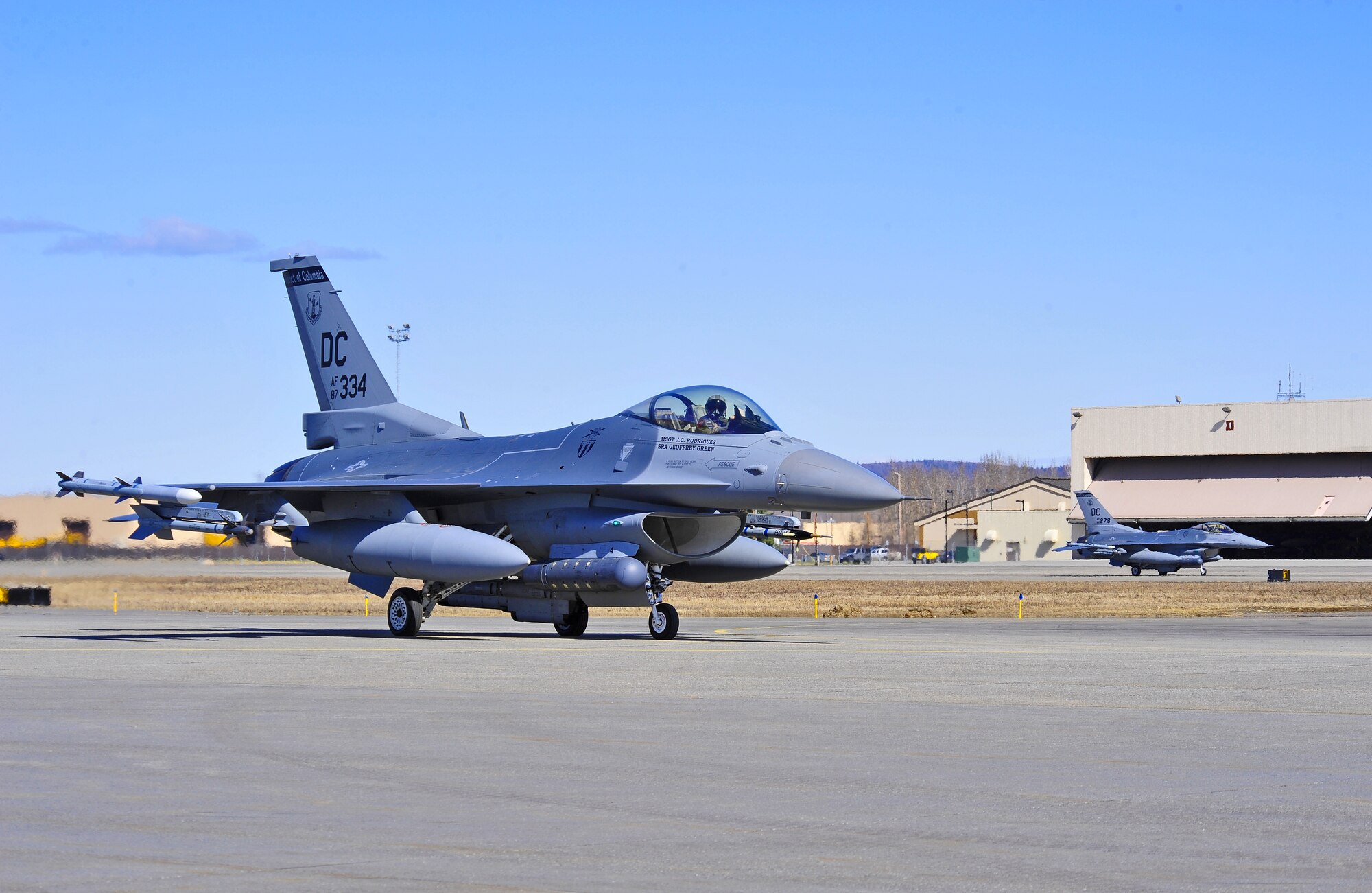 A pair of F-16 Fighting Falcon aircraft assigned to the 121st Fighter Squadron, Joint Base Andrews, Md., taxis down the flightline April 28, 2015, during Distant Frontier at Eielson Air Force Base, Alaska.  Distant Frontier is a preparation period during which RED FLAG-Alaska participants familiarize themselves with the airspace. (U.S. Air Force photo by Tech. Sgt. Miguel Lara III/Released)