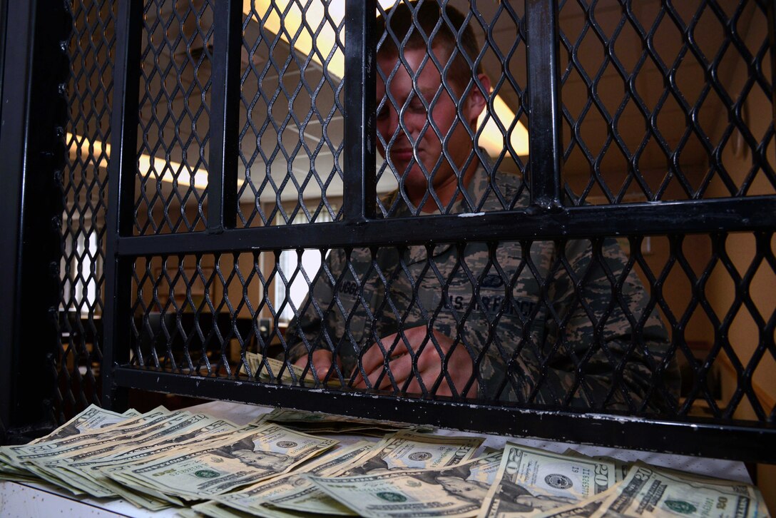 2nd Lt. Connor Niebrugge, 341st Comptroller Squadron deputy dispersing officer, counts cash April 29, 2015, at Malmstrom Air Force Base, Mont. Cash is stored in the 341st CPTS vault for safekeeping after it has been collected at the dining facility. (U.S. Air Force photo/Airman 1st Class Dillon Johnston)