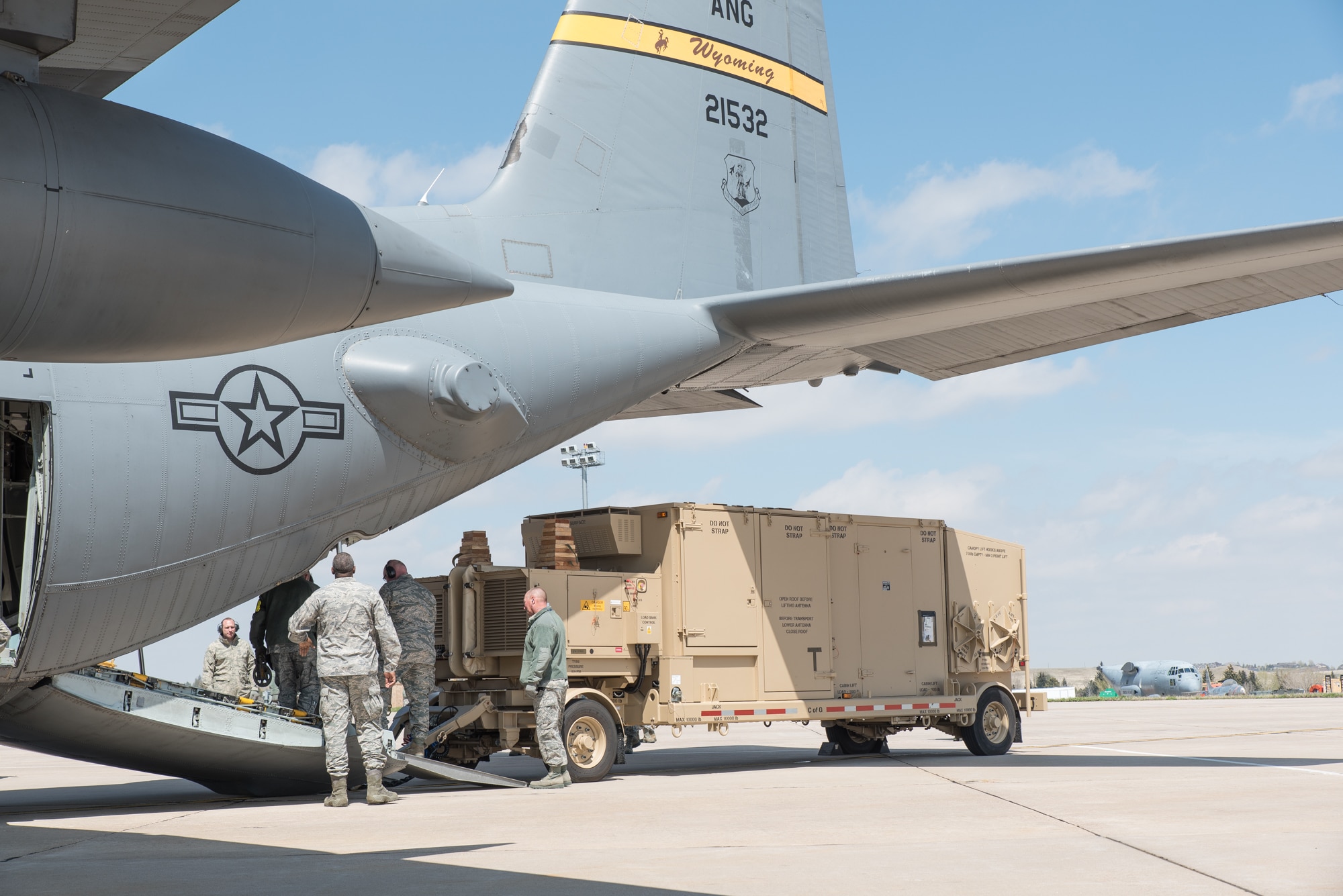 U.S. Air Force Airmen assigned to the Wyoming Air National Guard load a TRN-48 Tactical Air Navigation (TACAN) system on a C-130H Hercules aircraft Apr. 28, 2015 at Cheyenne Air National Guard base in Cheyenne, Wyoming. Guardsmen representing logistics, operations, maintenance, and air traffic control collaborated to load the equipment for the first time on a Wyoming C-130. Over 50 Airmen from the 243 Air Traffic Control Squadron are departing to Volk Field, Wisconsin to perform preparation and setup training for Deployable Air Traffic Control Landing Systems. (U.S. Air National Guard photo by Master Sgt. Charles Delano)