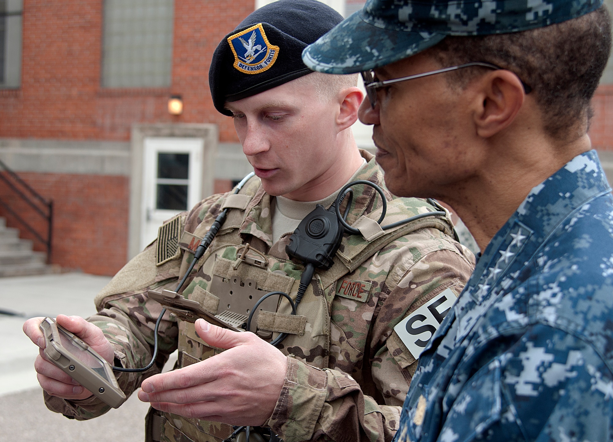 U.S. Air Force Airman Shane Michalik, 790th Missile Security Forces Squadron convoy response force member, shows  U.S. Navy Adm. Cecil D. Haney, U.S. Strategic Command commander, communication gear used in the field during his visit by Haney to F.E. Warren Air Force Base, Wyo., April 28, 2015. Haney traveled to F.E. Warren to see firsthand the men and women performing the ICBM mission 24/7, 365, and to chair the Intercontinental Ballistic Missile Stakeholders meeting, one of several such meetings that will be held this year. USSTRATCOM is one of nine DoD unified combatant commands and is charged with strategic deterrence; space operations; cyberspace operations; joint electronic warfare; global strike; missile defense; intelligence, surveillance and reconnaissance; combating weapons of mass destruction; and analysis and targeting. (U.S. Air Force photo by Airman 1st Class Brandon Valle)