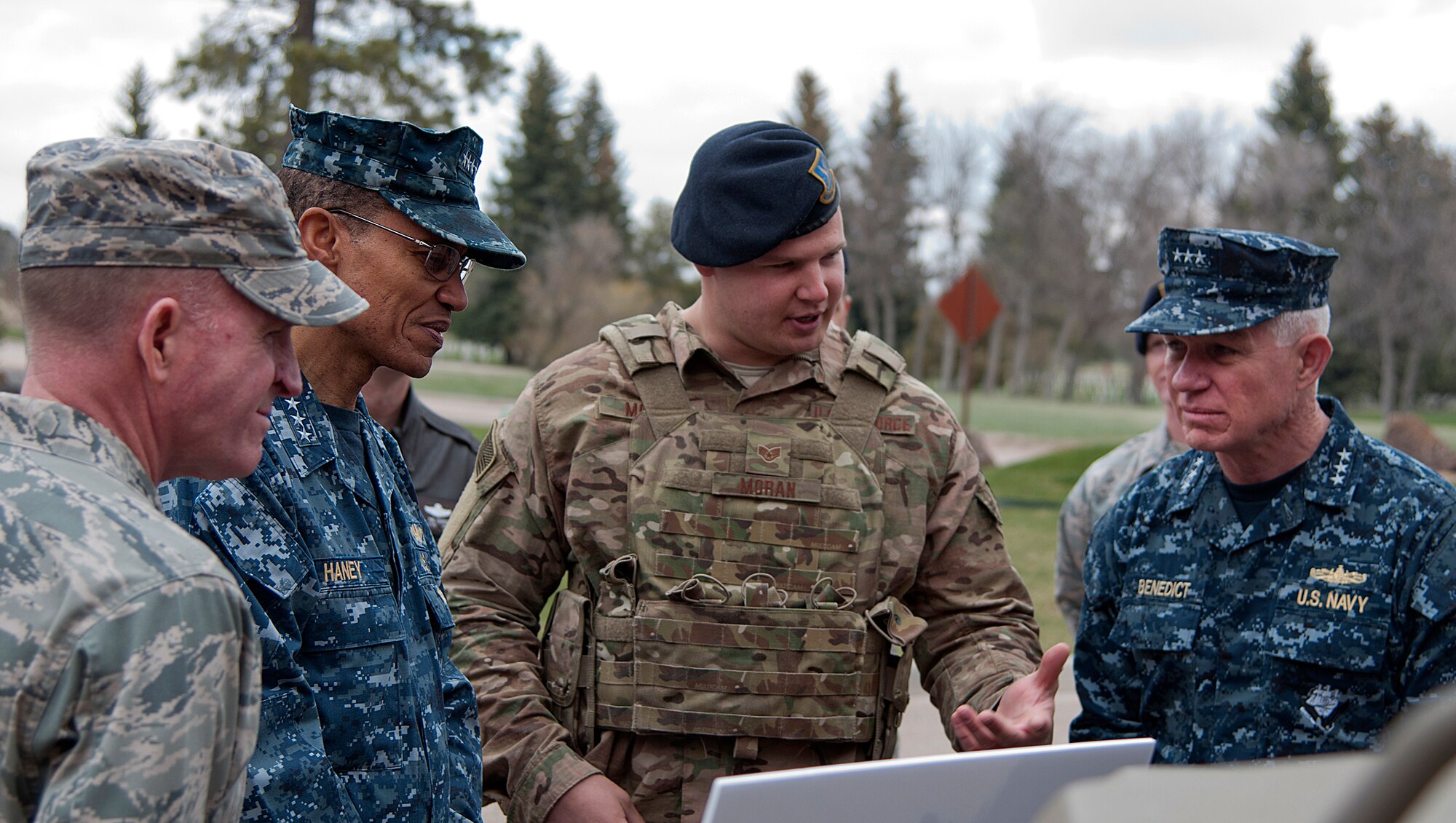 U.S. Air Force Staff Sgt. Sean Moran, 90th Security Forces Support Squadron, briefs U.S. Navy Adm. Cecil D. Haney, U.S. Strategic Command commander; U.S. Air Force Lt. Gen. Stephen W. Wilson, Air Force Global Strike Command commander; and U.S. Navy Vice Adm. Terry Benedict, U.S. Navy Strategic Systems Program director; on a wave relay tactical assault kit radio during a visit to F.E. Warren Air Force Base, Wyo., April 28, 2015. Haney, Wilson and Benedict traveled to F.E. Warren to see firsthand the men and women performing the ICBM mission 24/7, 365, and to attend the Intercontinental Ballistic Missile Stakeholders meeting, one of several such meetings that Haney will chair this year. USSTRATCOM is one of nine DoD unified combatant commands and is charged with strategic deterrence; space operations; cyberspace operations; joint electronic warfare; global strike; missile defense; intelligence, surveillance and reconnaissance; combating weapons of mass destruction; and analysis and targeting. (U.S. Air Force photo by Airman 1st Class Brandon Valle)