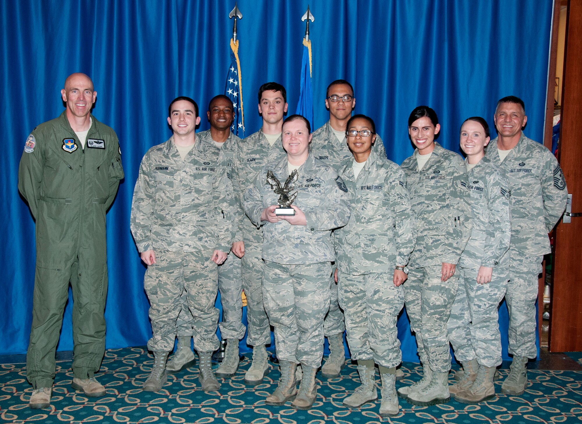 71st Operations Support Squadron aviation resource managers accept the Sergeant Dee Campbell Small Unit of the Year Award during a wing recognition ceremony here March 30 from Col. Clark Quinn (left), the 71st Flying Training Wing commander, and Command Chief Master Sgt. Peter Speen (right), the 71st FTW command chief. They received their award for efforts between October 2013 and September 2014. (U.S. Air Force photo/Terry Wasson)