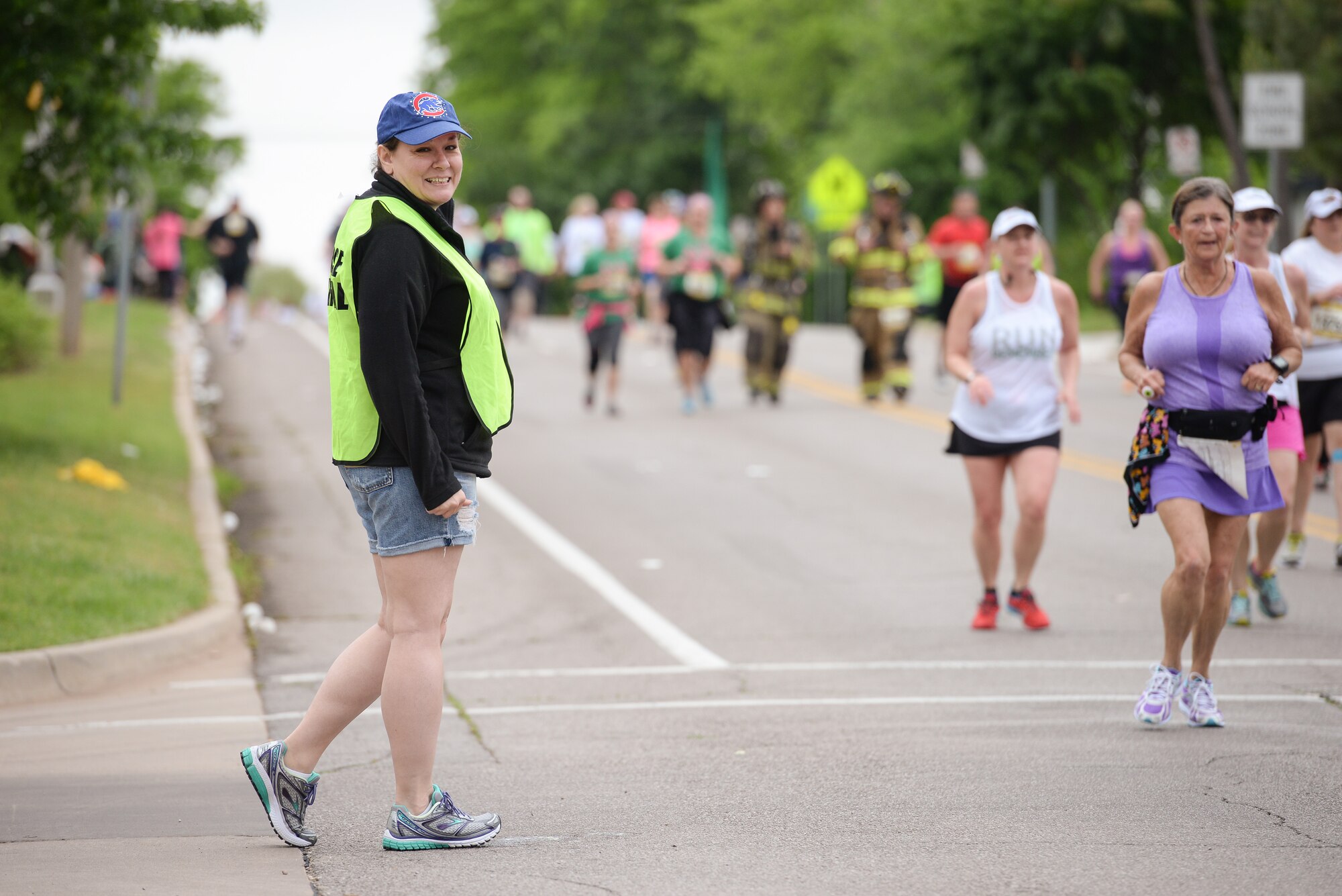 Master Sgt. Sharon Lochman, a career advisor assigned to the 507th Force Support Squadron at Tinker Air Force Base, Okla., stands guard at an intersection to keep runners safe from oncoming traffic during the Oklahoma City Memorial Marathon on April 26 in Oklahoma City. Lochman was one of 25 reservists to volunteer as course marshals for the marathon. (U.S. Air Force photo/Staff Sgt. Caleb Wanzer)