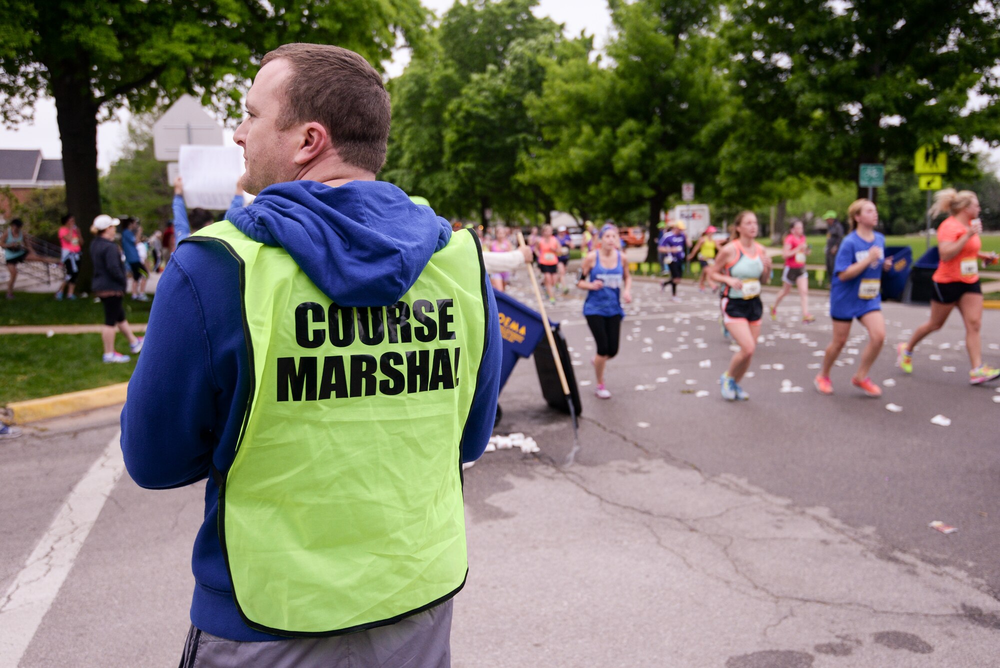 Senior Master Sgt. Brent Slattery, assigned to the 35th Combat Communications Squadron at Tinker Air Force Base, Okla., checks for traffic during the Oklahoma City Memorial Marathon on April 26 in Oklahoma City. Slattery was one of 25 reservists to volunteer as course marshals for the marathon. (U.S. Air Force photo/Staff Sgt. Caleb Wanzer)