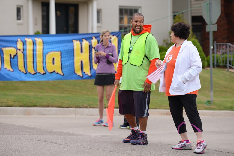 Master Sgt. Alphonzo Glover, an accessories flight chief with the 513th Maintenance Squadron at Tinker Air Force Base, Okla., talks with a community member on the sidelines of the Oklahoma City Memorial Marathon on April 26 in Oklahoma City. Glover was one of 25 reservists to volunteer as course marshals for the marathon. (U.S. Air Force photo/Staff Sgt. Caleb Wanzer)