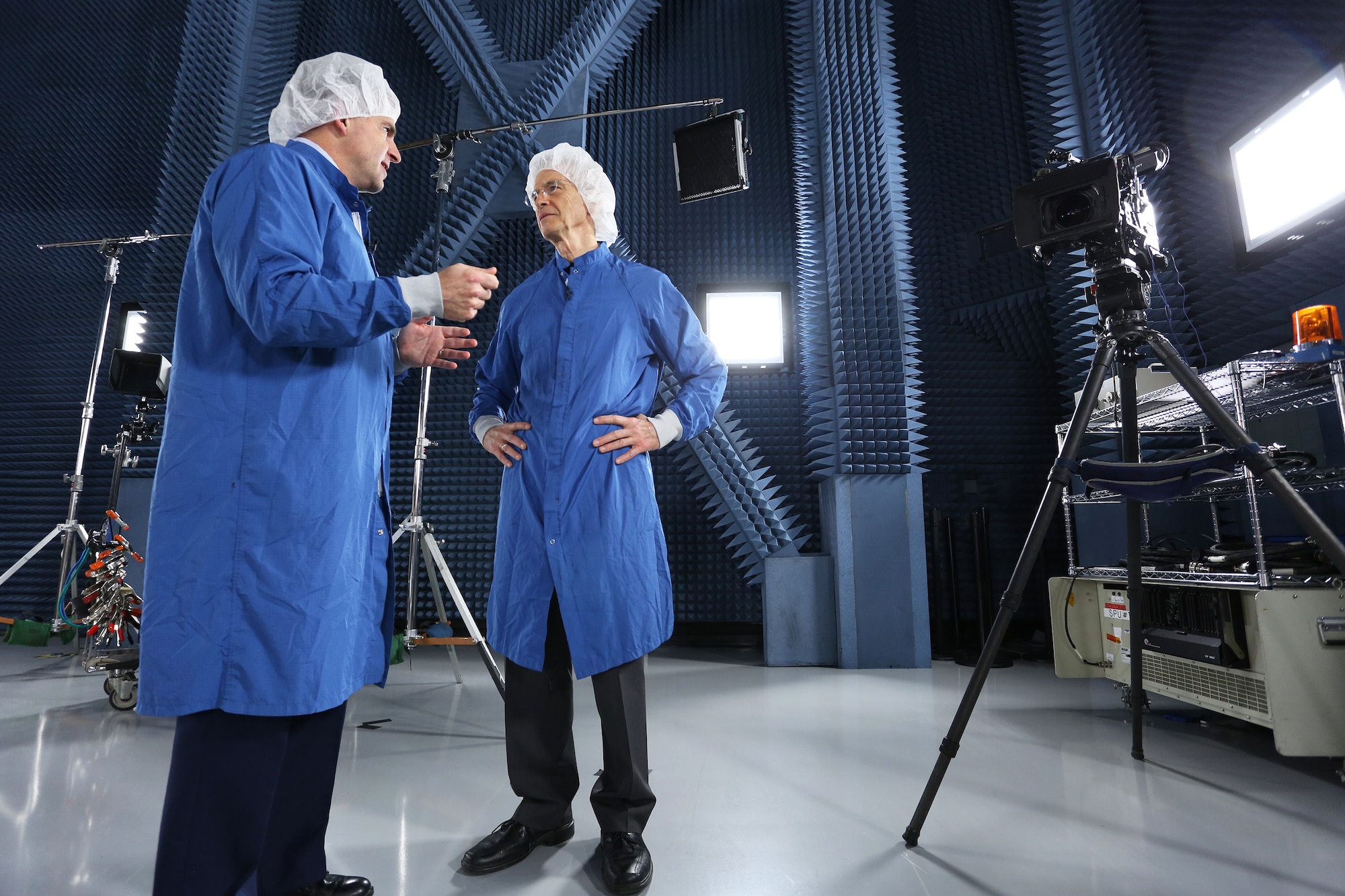 CBS/60 Minutes correspondent Dave Martin (right) interviews Brig. Gen. Bill Cooley, director of the GPS directorate for the Space and Missile Systems Center, inside a special satellite test chamber at the Boeing facility in El Segundo, California for a two-part segment on Air Force Space Command that aired April 26, 2015. (Photo by Maj Eric Simon)