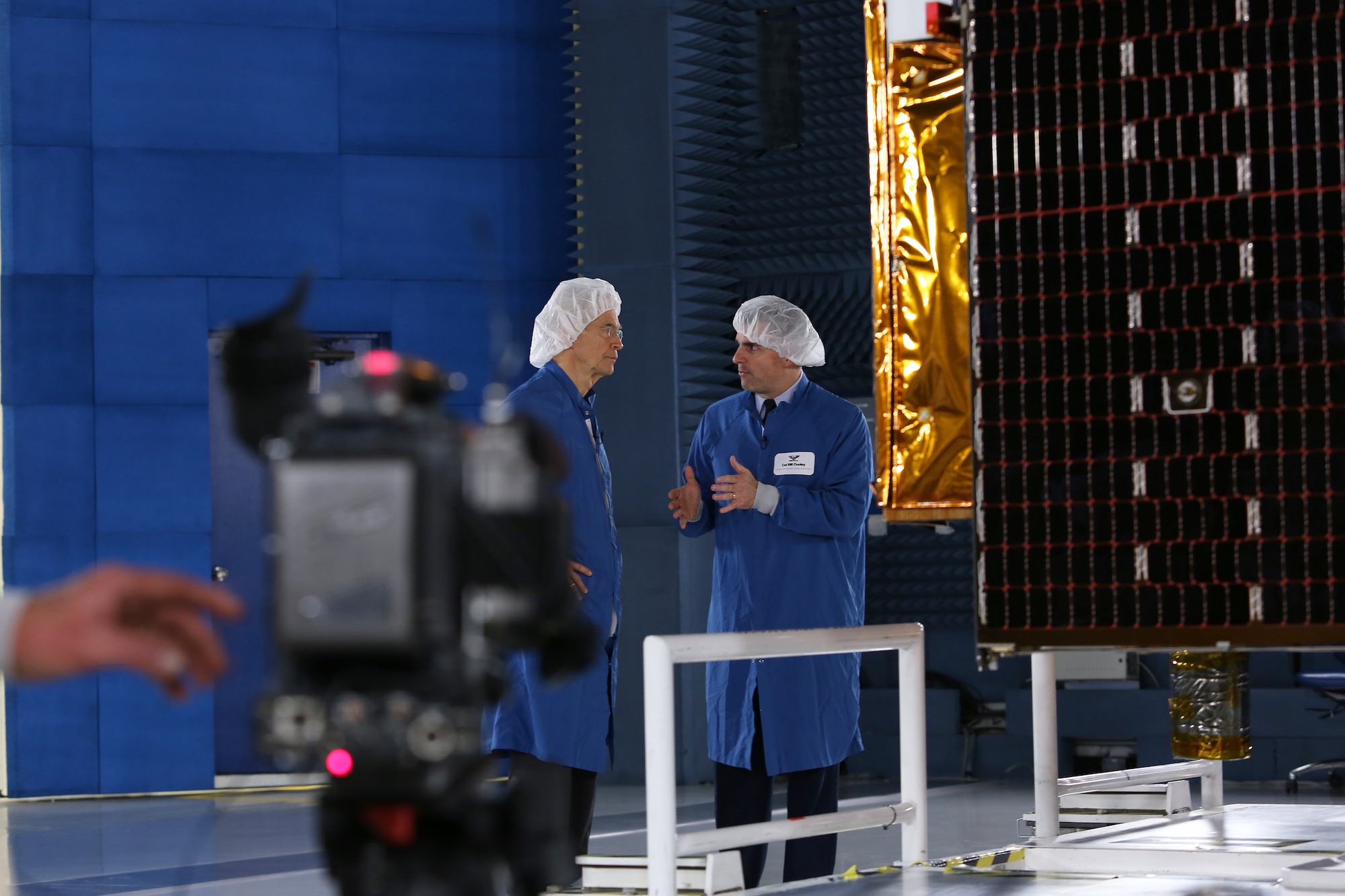 CBS/60 Minutes correspondent Dave Martin (left) interviews Brig. Gen. Bill Cooley, director of the GPS directorate for the Space and Missile Systems Center, next to a GPS-IIF satellite at the Boeing facility in El Segundo, California for a two-part segment on Air Force Space Command that aired April 26, 2015. (Photo by Maj Eric Simon)