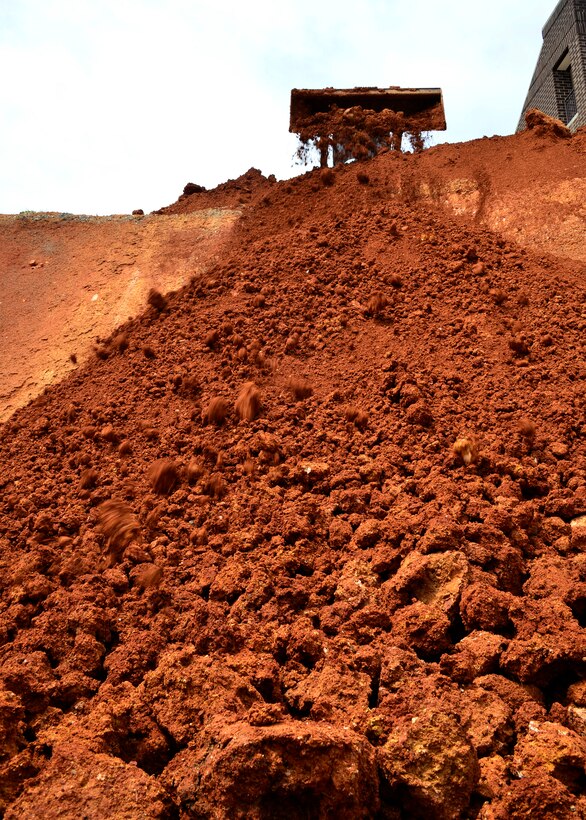 McGHEE TYSON AIR NATIONAL GUARD BASE, Tenn. - A construction crew member pushes dirt towards the retaining wall at the mixed-use facility construction site here Apr. 29, 2015 at the I.G. Brown Training and Education Center. An estimated 50 dump truck loads of dirt and gravel will be needed to fill in the excavated area. The new TEC dormitory and classroom facility will contain approximately 47,000 square feet of additional space on three levels and two levels with ten 20-person and two 100-person classrooms, HD audio/visual capabilities, wireless capability, 97 single occupancy dorm rooms, energy efficient natural and led lighting, hearing and mobility accessible accommodations. (U.S. Air National Guard photo by Master Sgt. Jerry D. Harlan/Released)