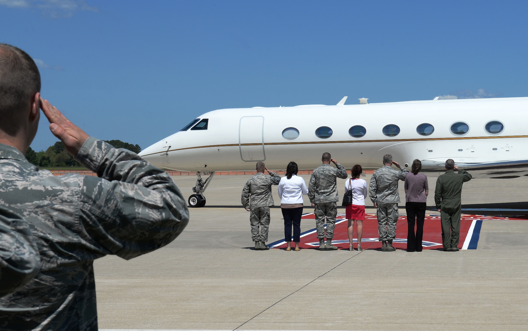 Airmen and leaders from Langley Air Force Base give a final salute as U.S. Air Force Chief of Staff Gen. Mark A. Welsh III, and his team leave Langley. During a three-day visit to Langley, Welsh and his wife, Betty, spoke with Airmen regarding issues in the Air Force that affect them now and may affect them in the future. (U.S. Air Force photo by Staff Sgt. Teresa J. Cleveland/Released) 