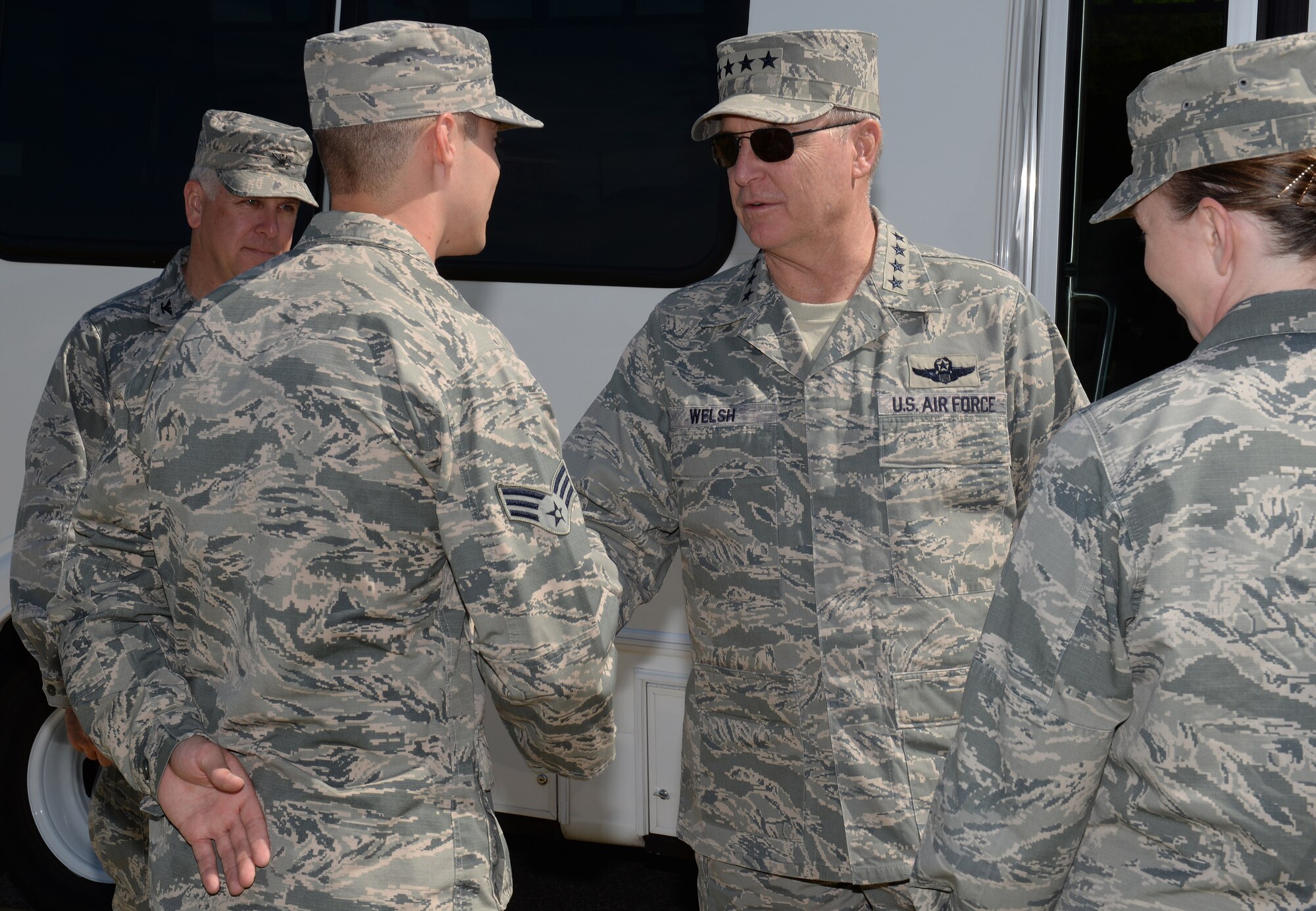 U.S. Air Force Senior Airman Shane Posey, 633rd Medical Support Squadron biomedical equipment journeyman, receives a coin from U.S. Air Force Chief of Staff Gen. Mark A. Welsh III, during a base tour at Langley Air Force Base, Va., April 29, 2015. During his visit, Welsh recognized Airmen from various units who have performed at outstanding levels. (U.S. Air Force photo by Staff Sgt. Teresa J. Cleveland/Released) 