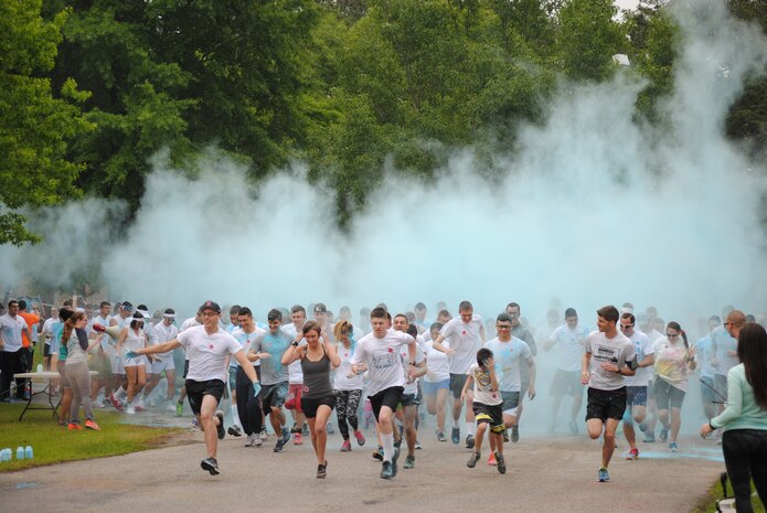 Runners take off at the starting line of the second annual Paint Run 5K  Fun Run April 25, 2015 at Joint Base Charleston - Weapons Station, S.C. More than 300 people participated in the free event  that was open to everyone and was co-hosted by Joint Base Charleston Sexual Assault Prevention and Response Program and Sam's Fitness Center. April is sexual assault awareness month and this year’s theme is, “Eliminate Sexual Assault: Know your part. Do your part.” The purpose of sexual assault awareness month is to raise awareness about sexual assault prevention and support sexual assault survivors. (Courtesy Photo / Jacque Gardner)
