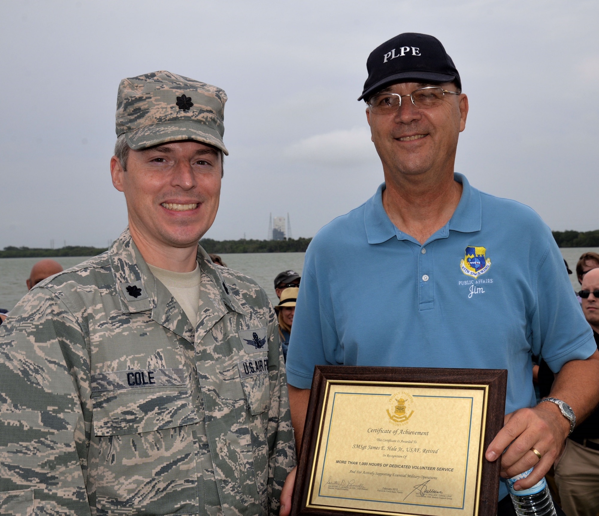 Lt. Col. Anthony Cole, 45th Mission Support Group Detachment 1 commander, presents retired Air Force veteran, Jim Hale, Project Emeritus volunteer, with a certificate of appreciation recognizing more than 1,000 hours of volunteer service to the 45th Space Wing, April 27, 2015, at Cape Canaveral Air Force Station, Fla. Hale volunteers his time escorting media on behalf of Public Affairs and conducts several tours of CCAFS. To become a volunteer, contact Project Emeritus at (321) 494-7656. (Courtesy photo by Julian Leek)  