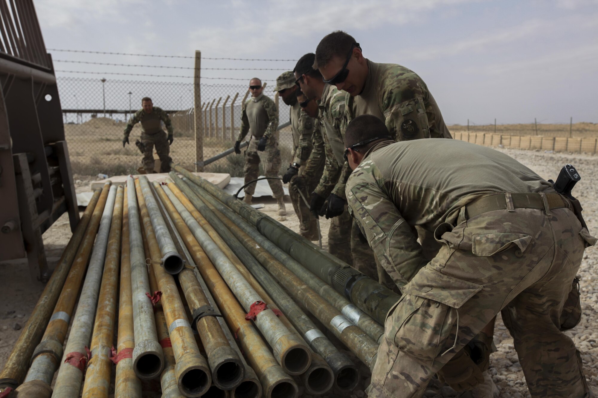 Liberty Wing reservist, Tech. Sgt. Christopher Panico, along with Airmen attached to the 577th Expeditionary Prime Base Emergency Engineering Force Squadron move and organize pipes as part of their mission to assess the well for an emergency water supply for the Operation Inherent Resolve Building Partner Capacity Mission aboard Al-Asad Airbase, Iraq, April 11, 2015. The BPC mission will train and enable Iraqi Security Force leadership skills, medical procedures, small unit tactics, air-ground integration, and equipping and sustainment procedures. (U.S. Marine Corps Photo by Cpl. Cansin P. Hardyegritag)