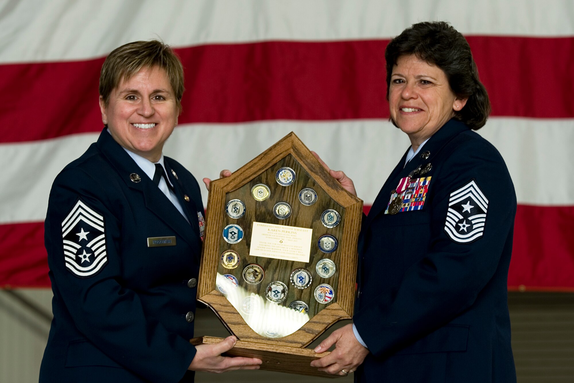 Chief Master Sgt. Karen Perkins, 434th Air Refueling Wing command chief, poses for a photo after receiving a shadow box from retired Chief Master Sgt. Peri Rogowski during her retirement ceremony at Grissom Air Reserve Base, Ind., April 12, 2015. Perkins officially retires from the Air Force Reserve May 1, with over 32 years of service. (U.S. Air Force photo/Senior Airman Jami K. Lancette)