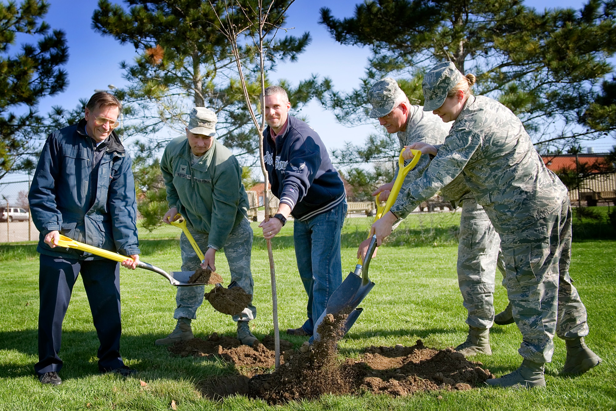 Grissom employees plant a Yoshino cherry tree at Grissom Air Reserve Base, Ind., Apr. 24, 2015. From the left, they are David Hughes, 434th Civil Engineer Squadron civil engineer, Col. Scott Russell, 434th Mission Support Group commander, Cory Walters, 434th CES biological scientist, Senior Master Sgt. Tim Wood, 434th Air Refueling Wing honor guard director, and 2nd Lt. Stephanie Creel, 434th MSG Yellow Ribbon Program manager. (U.S. Air Force photo/Tech. Sgt. Douglas Hays)