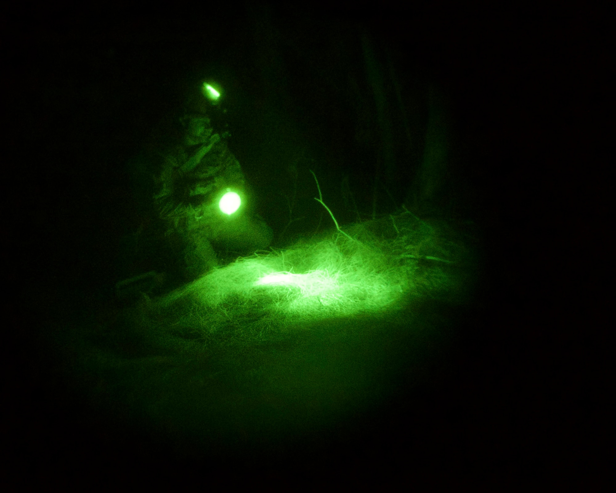 Staff. Sgt. Jason Cohen, 482nd Civil Engineering Squadron Explosive Ordnance Disposal Flight team member, uses an infrared light and night vision goggles to locate and examine an improvised explosive device during night operations at Homestead Air Reserve Base, Fla., April 8. The EOD Flight conducted dismounted counter-IED operations as part of a weeklong training exercise aimed to prepare the reservists for combat operations. (U.S. Air Force photo by Staff Sgt. Jaimi L. Upthegrove)