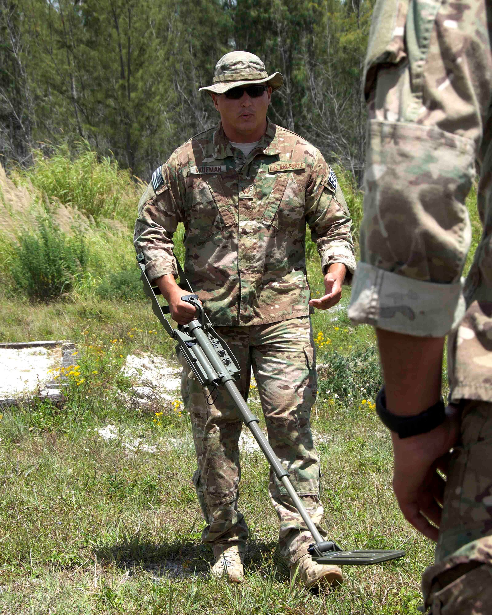 Tech. Sgt. Steve Kaufman, team leader for the 482nd Civil Engineering Squadron Explosive Ordnance Disposal Flight, demonstrated how to use a compact metal detector at Homestead Air Reserve Base, Fla., April 6. The EOD Flight used the compact metal detectors to assist in locating improvised explosive devices that may be buried during a weeklong dismounted counter-IED operation training exercise aimed to prepare the reservists for combat operations. (U.S. Air Force photo by Staff Sgt. Jaimi L. Upthegrove)