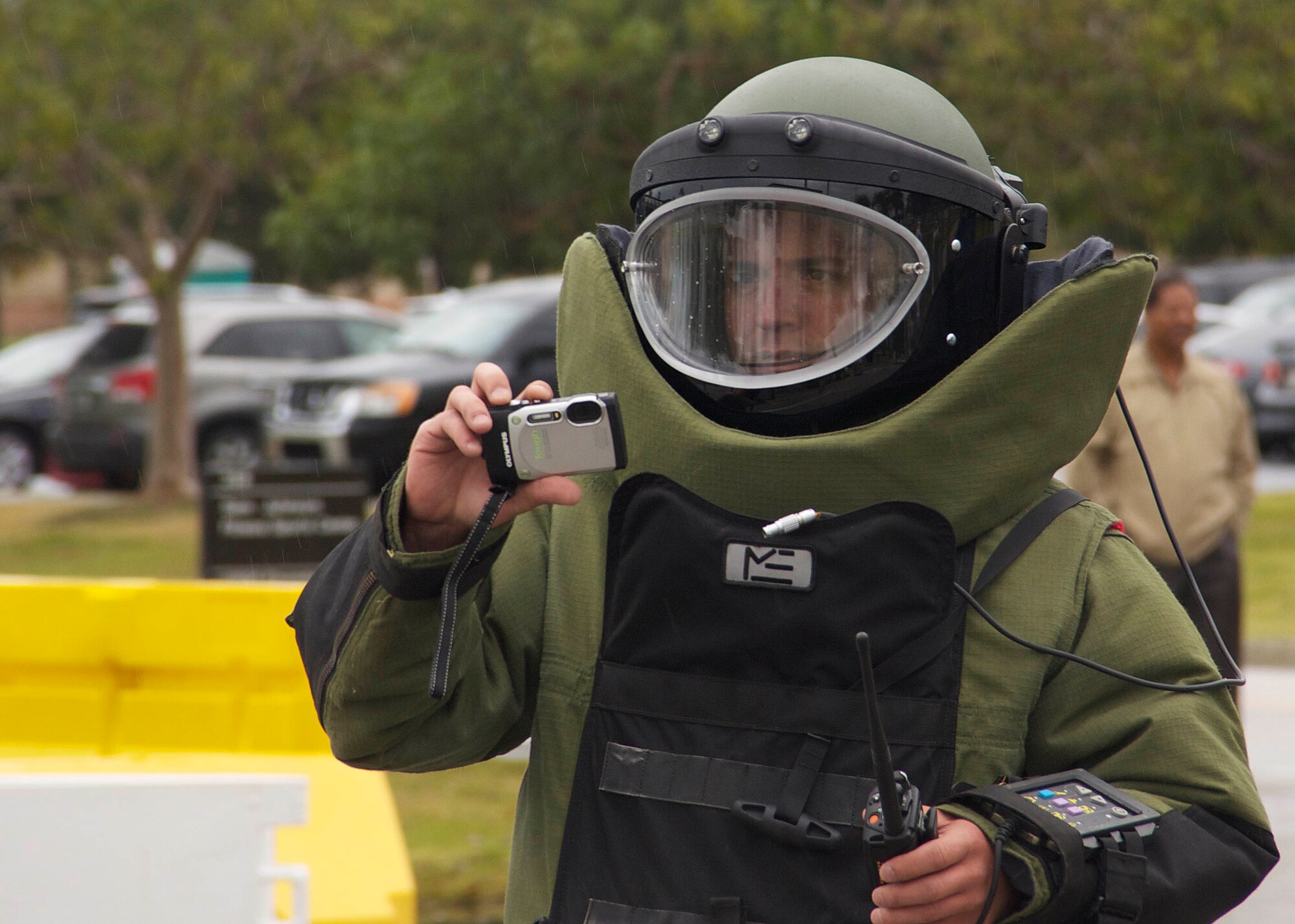 Tech. Sgt. Aaron Johns, 482nd Civil Engineering Squadron Explosive Ordnance Disposal Flight team leader, photographs the scene during a suspect package exercise at Homestead Air Reserve Base, Fla., Feb. 18. Johns is the only member of the team who was at the scene in person wearing an EOD 9 bomb suit. He takes photos to show the rest of the team so they can decide how to safely handle the incident. (U.S. Air Force photo by Staff Sgt. Jaimi L. Upthegrove)