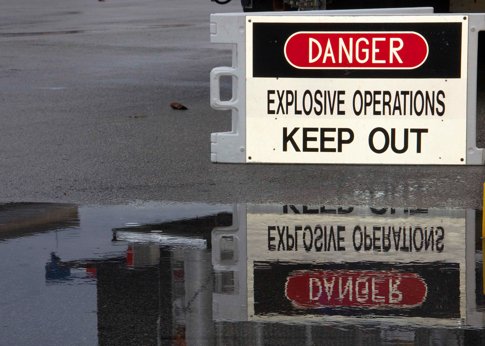 The 482nd Civil Engineering Squadron Explosive Ordnance Disposal Flight conducted a suspect package exercise at Homestead Air Reserve Base, Fla., Feb. 18. When the EOD Flight responds to calls they mark off an initial cordon with these signs and Security Forces responds to help maintain the cordon and redirect traffic. (U.S. Air Force photo by Staff Sgt. Jaimi L. Upthegrove)