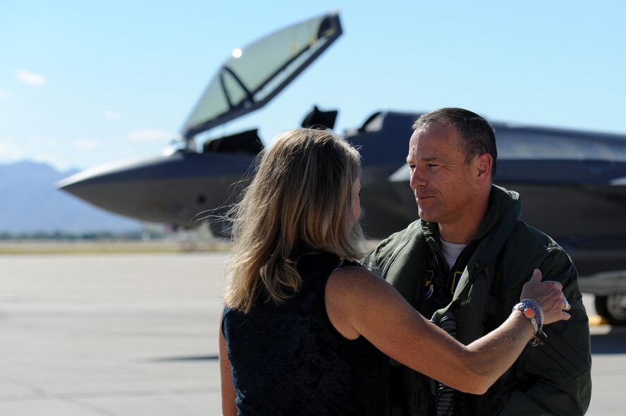 Brig. Gen. Scott Pleus, 56th Fighter Wing commander, greets his wife, Jennifer, after landing the flagship F-35 Lightning ll at Luke Air Force Base, Arizona, April 28, 2015. The flagship's arrival coincides with the start of Luke F-35 student pilot training, which begins in May. Luke now has 20 U.S. F-35s and two from the Royal Australian Air Force. (U.S. Air Force photo by Staff Sgt. Staci Miller)