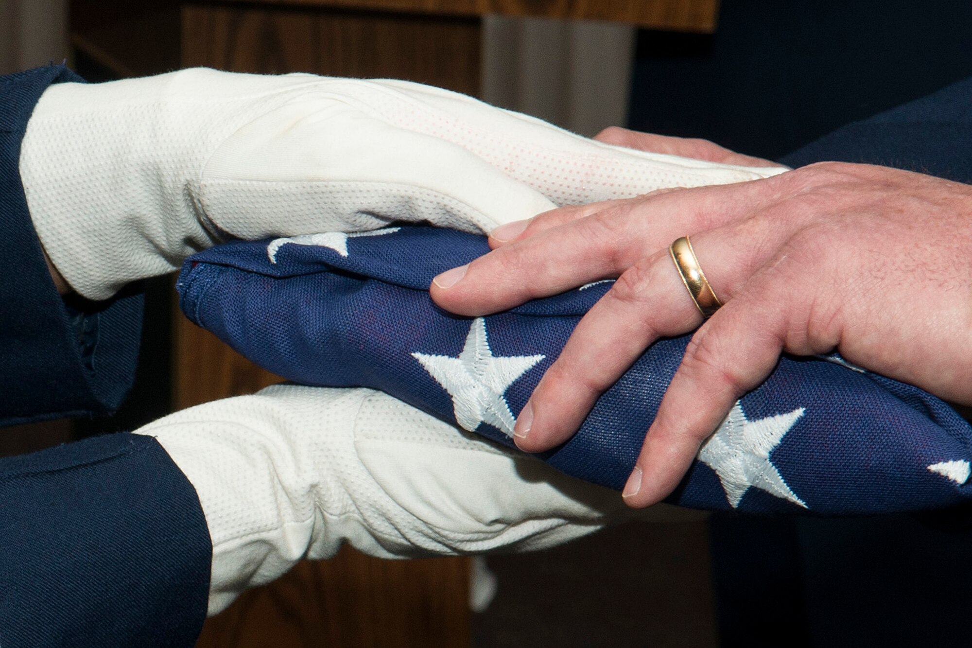 U.S. Air Force Chief Master Sgt. Mark Traynham is presented with an American Flag during his retirement ceremony on April 25, 2015, Barksdale Air Force Base, La. Traynham is the Security Forces Manager assigned to the 307th Security Forces Squadron and is retiring from the Air Force Reserve after 33 years of service. (U.S. Air Force photo by Master Sgt. Greg Steele/Released)