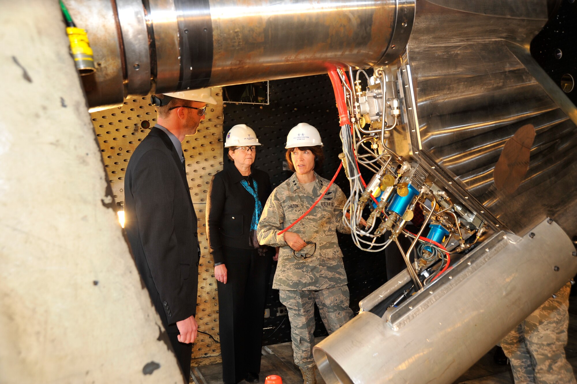 Maj. Gen. Catherine Chilton (right), Air Force Materiel Command Air, Space and Information Operations (AFMC/A3) director, discusses the operation of the Propulsion Wind Tunnel (PWT) Wings Level Yaw (WLY) apparatus with AEDC Senior Acquisition Program Manager Elijah Minter (left) during a tour of the Complex on March 18. The WLY provides quality data and an increased yaw range capability during aerodynamic testing. Dr. Eileen Bjorkman, a member of the Senior Executive Service and AFMC/A3 deputy, is also pictured attending the tour. (Photo by Rick Goodfriend)