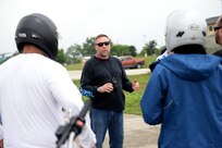 Glen Griffin, a volunteer motorcycle safety instructor, explains instructions for the next section of training April 24 during the Basic Rider Course at the Joint Base San Antonio-Lackland Training Annex. The Basic Rider Course is a free class offered by the 502nd Air Base Wing Safety office to teach safe riding practices to future or current motorcyclists. The course is required for all riders who will be riding on an Air Force installation.   (U.S. Air Force photo by Staff Sgt. Marissa Garner)