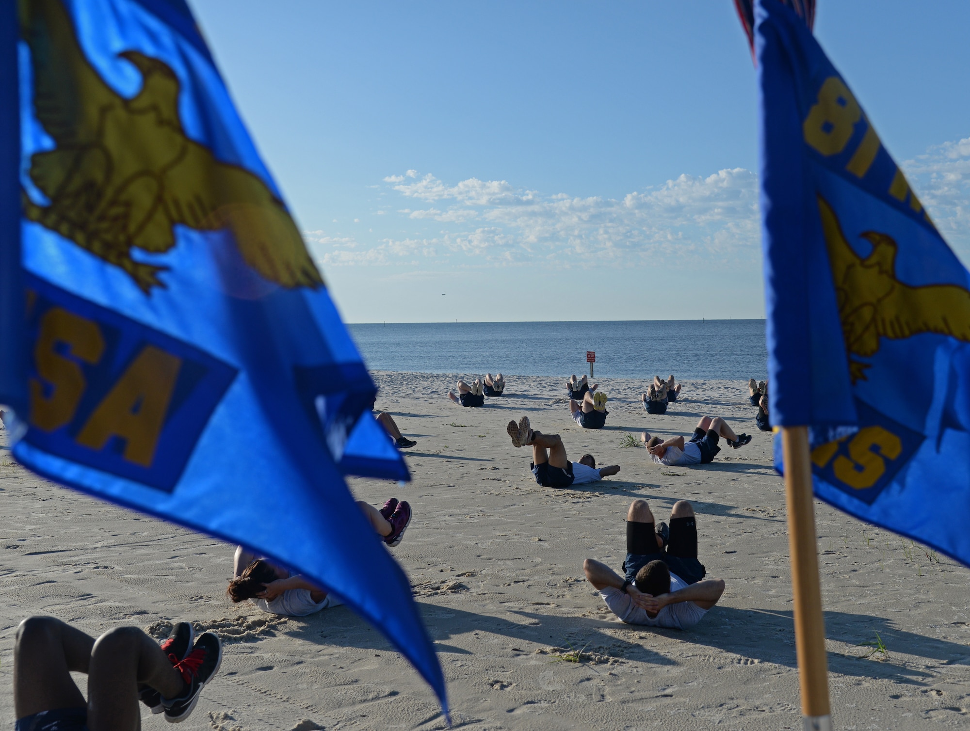 Members of Team Keesler perform different aerobic exercises during the 85th Engineering Installation Squadron physical training event at the beach, April 22, 2015, Biloxi, Miss. The 85th EIS invited other Keesler members to participate in the 90-minute PT session which also included a 1.5 mile run. (U.S. Air Force photo by Senior Airman Holly Mansfield)