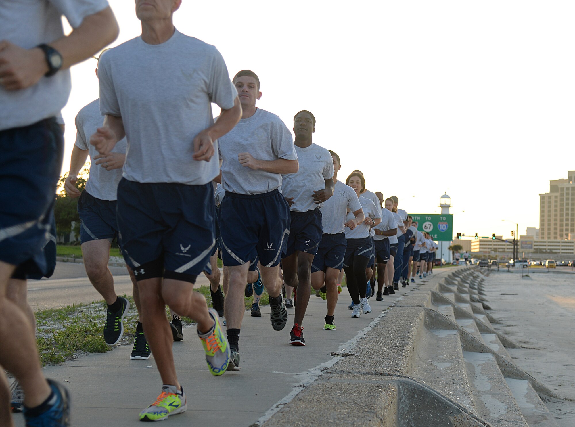 Members of Team Keesler participate in a 1.5 mile run during the 85th Engineering Installation Squadron’s physical training event at the beach, April 22, 2015, Biloxi, Miss.  The 85th EIS invited other Keesler members to participate in the 90-minute PT session that also included different stations for aerobic exercises. (U.S. Air Force photo by Senior Airman Holly Mansfield)