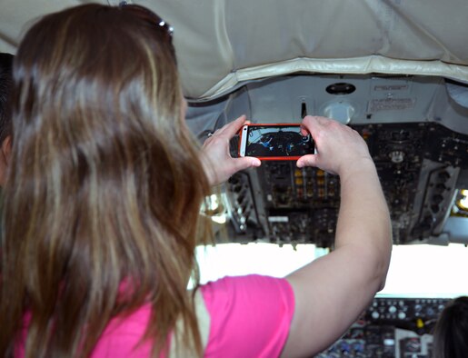 A military spouse takes a photo of another military spouse and her child as they sit in the pilots’ seats on a KC-135 Stratotanker April 24, 2015, during the 100th Maintenance Group’s Spouse Appreciation Day event on RAF Mildenhall, England. During the event, family members were given a tour of workcenters in the 100th Operations Group and the 100th MXG, and a hands-on tour of a KC-135. (U.S. Air Force photo by Karen Abeyasekere/Released)