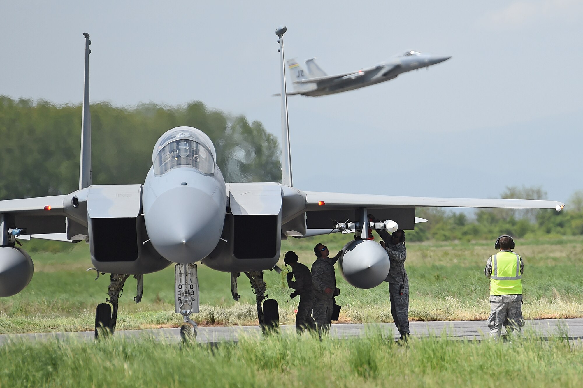 Airmen with the 159th Aircraft Maintenance Squadron, Louisiana Air National Guard, perform and end of runway inspection prior to takeoff of an F-15C Eagle, April 28, 2015, Graf Ignatievo Air Base, near Plovdiv, Bulgaria. Thracian Eagle 2015 is intended to enhance interoperability with Bulgaria and maintain joint readiness with NATO allies. (U.S. Air National Guard photo by Master Sgt. Toby M. Valadie, 159th Public Affairs Office/Released)
