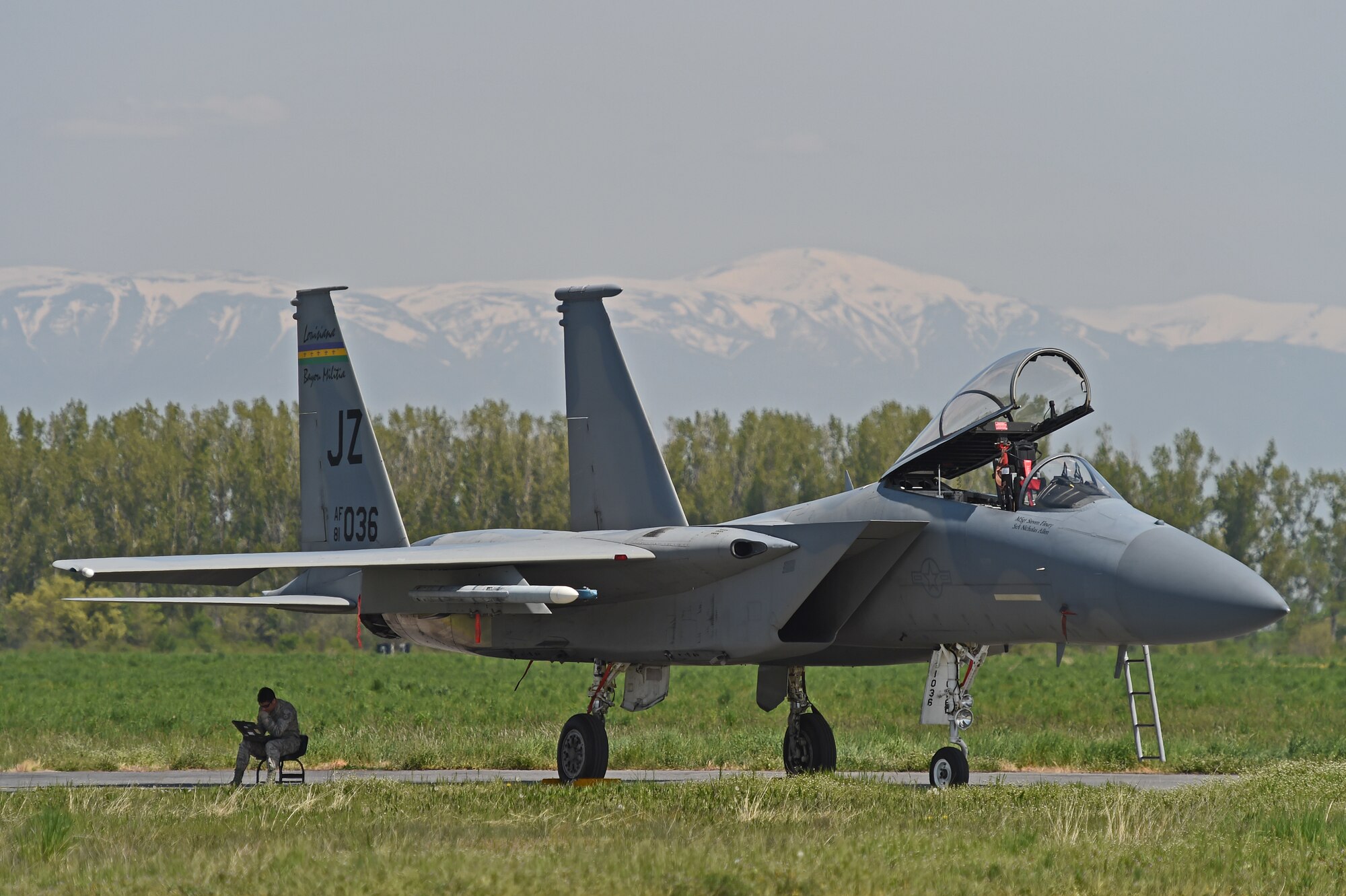 Tech. Sgt. Josh Bravo, F-15 crew chief, 159th Aircraft Maintenance Squadron, Louisiana Air National Guard, reviews E-tools between sorties under the shade of an F-15C Eagle, April 24, 2015, Graf Ignatievo Air Base, near Plovdiv, Bulgaria. E-Tools is an electronic technical order for maintaining military equipment. (U.S. Air National Guard photo by Master Sgt. Toby M. Valadie, 159th Public Affairs Office/Released)