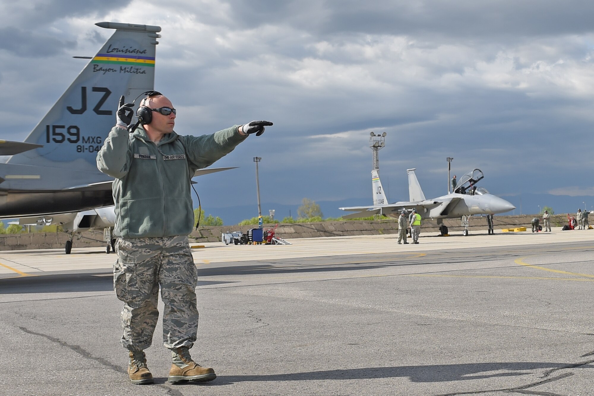 Tech. Sgt. Charles Fenton, F-15 crew chief, 159th Aircraft Maintenance Squadron, Louisiana Air National Guard, signals to an F-15C Eagle to throttle up and begin to taxi, April 22, 2015, Graf Ignatievo Air Base, near Plovdiv, Bulgaria. Thracian Eagle 2015 allows U.S. and NATO to demonstrate their shared commitment to a peaceful, stable and secure Europe. (U.S. Air National Guard photo by Master Sgt. Toby M. Valadie, 159th Public Affairs Office/Released)