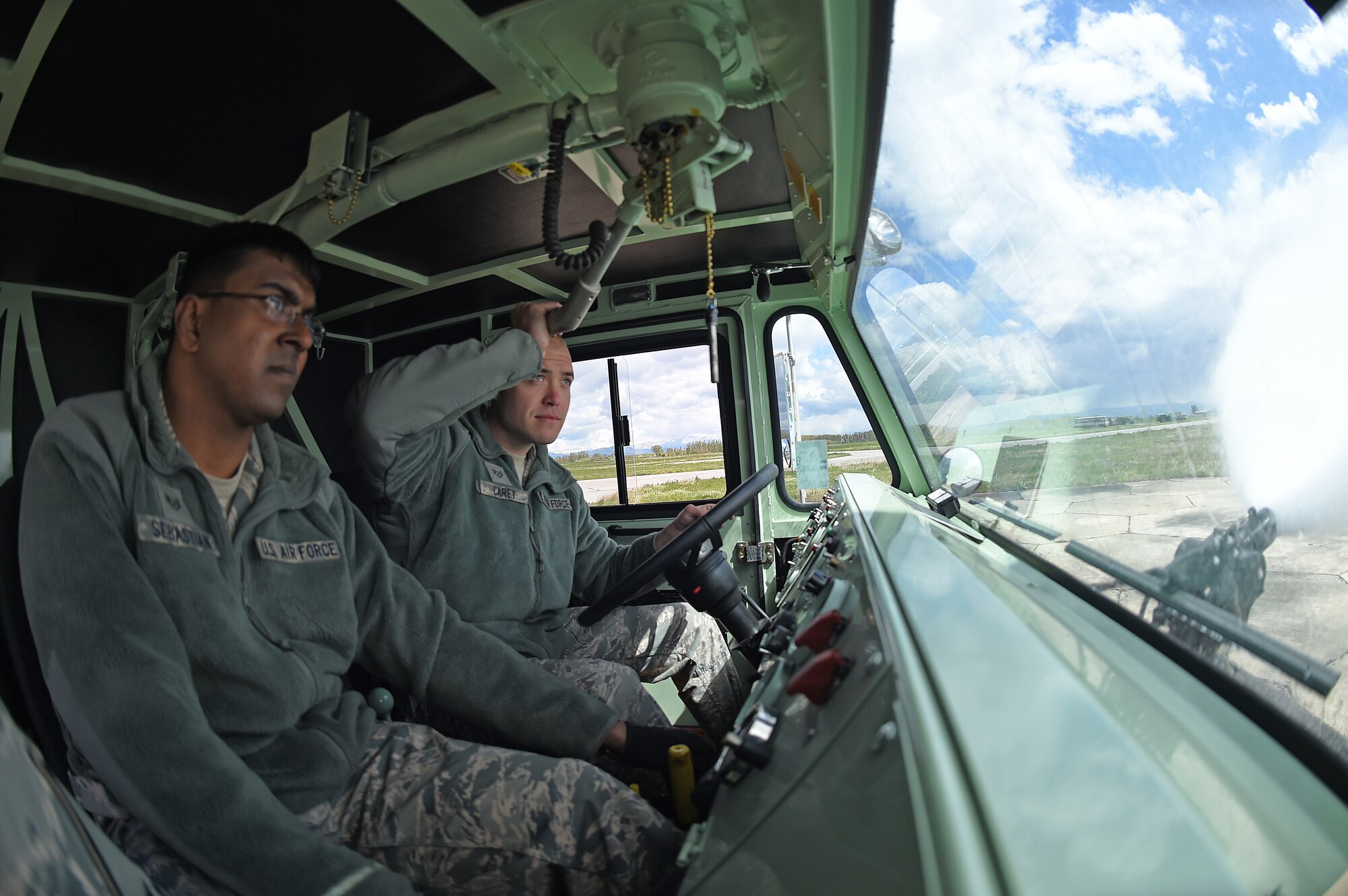 Staff Sgt. Arun Sebastian, 65th Air Base Wing, Lajes Field Air Base, Portugal, with Staff Sgt. Andrew Carey, 132nd Wing, Iowa Air National Guard, perform a functional check on a P-19 firetruck April 21, 2015, Graf Ignatievo Air Base, near Plovdiv, Bulgaria, in support of Thracian Eagle 2015. Thracian Eagle 2015 is a bilateral exercise between the 159th Fighter Wing, Louisiana Air National Guard, and the Bulgarian Air Force to enhance interoperability with United States and Bulgaria to maintain joint readiness with NATO allies. (U.S. Air National Guard photo by Master Sgt. Toby M. Valadie, 159th Public Affairs Office/RELEASED)