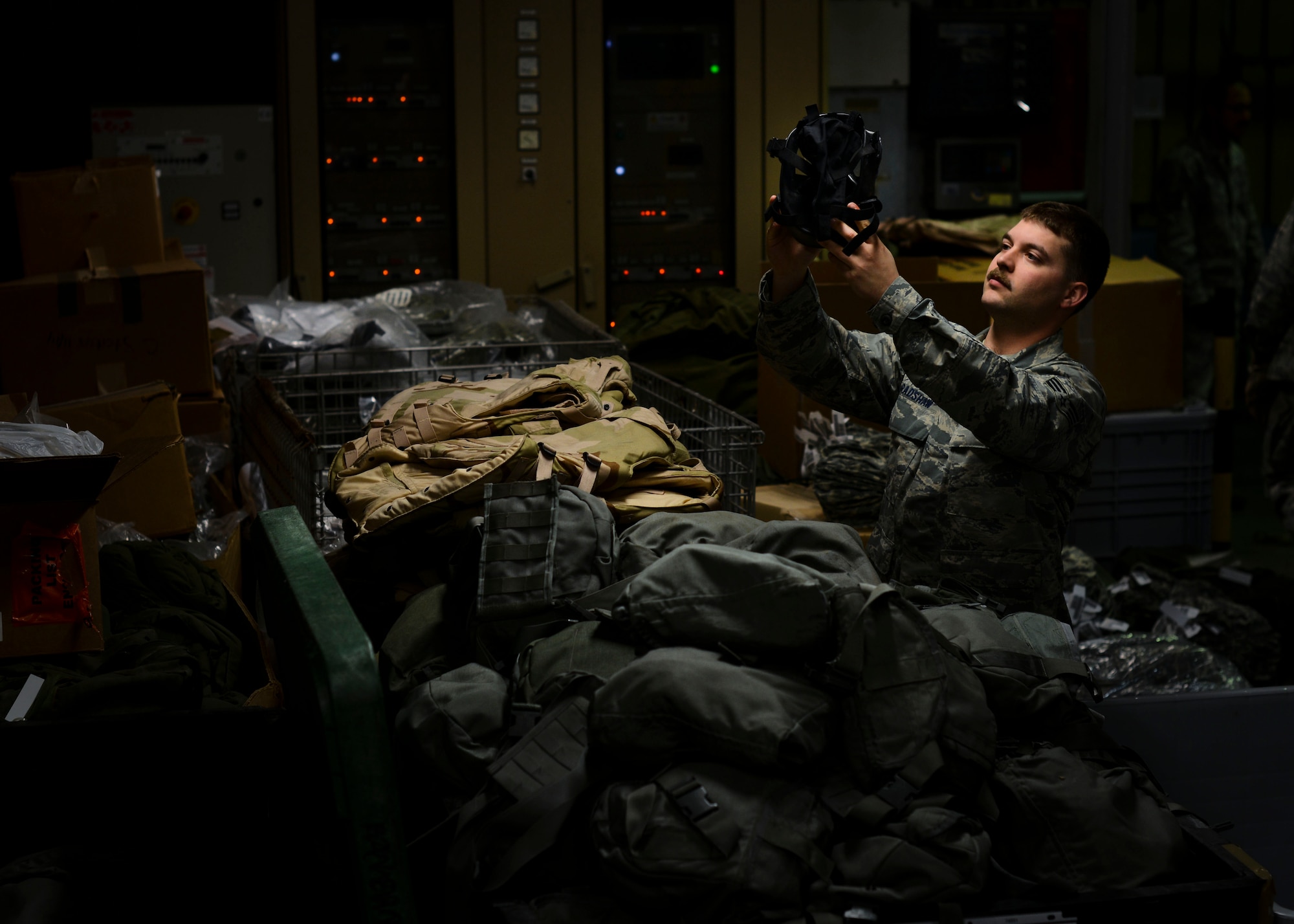 U.S. Air Force Senior Airman James Bradshaw, 31st Logistic Readiness Squadron individual protective equipment journeyman, inspects a gas mask, April 28, 2015, at Aviano Air Base, Italy. Airmen in IPE use specialized tools to ensure the functionality and condition of equipment. (U.S. Air Force photo by Senior Airman Austin Harvill/Released)