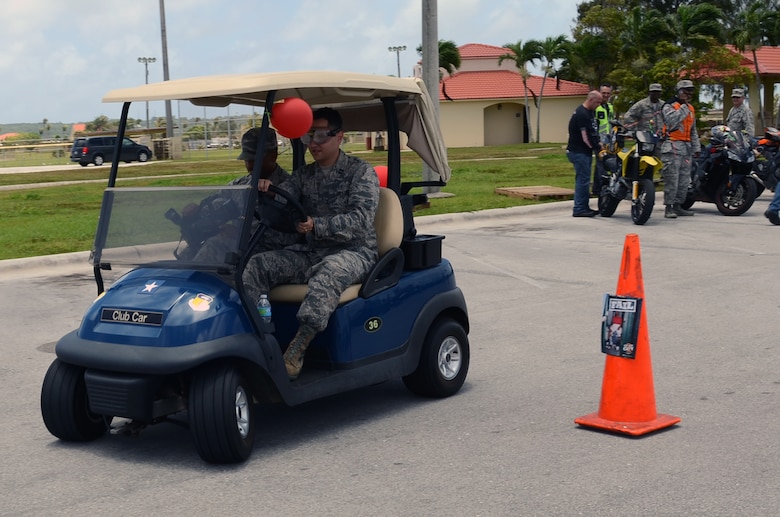 Capt. (Dr.) David Shwalb, 36th Medical Operations Squadron Mental Health Flight commander, drives the wing commander’s golf cart with impaired vision goggles at The Exchange at Andersen Air Force Base, Guam, April 24, 2015. The 36th MDOS Alcohol and Drug Abuse Prevention and Treatment program put on a drunken Mario Kart competition and a drunken golf cart obstacle course for participants to maneuver while wearing impaired vision goggles to show Airmen and their families the effects of alcohol on motor skills in recognition of Alcohol Awareness Month. (U.S. Air Force photo by Airman 1st Class Alexa Ann Henderson/Released)