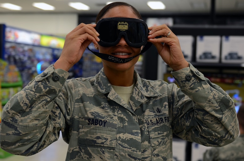 Staff Sgt. Danyelle Saboy, 36th Medical Support Squadron, tries on impaired vision goggles at The Exchange at Andersen Air Force Base, Guam, April 24, 2015. The 36th Medical Operations Squadron Alcohol and Drug Abuse Prevention and Treatment program put on a drunken Mario Kart competition and a drunken golf cart obstacle course for participants to maneuver while wearing impaired vision goggles to show Airmen and their families the effects of alcohol on motor skills in recognition of Alcohol Awareness Month. (U.S. Air Force photo by Airman 1st Class Alexa Ann Henderson/Released)