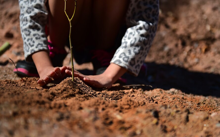 A child plants a tree in honor of Earth Day. For more tips on reducing your ecological footprint, visit www.earthday.org. (U.S. Air Force photo/Staff Sgt. Sara Keller) 
