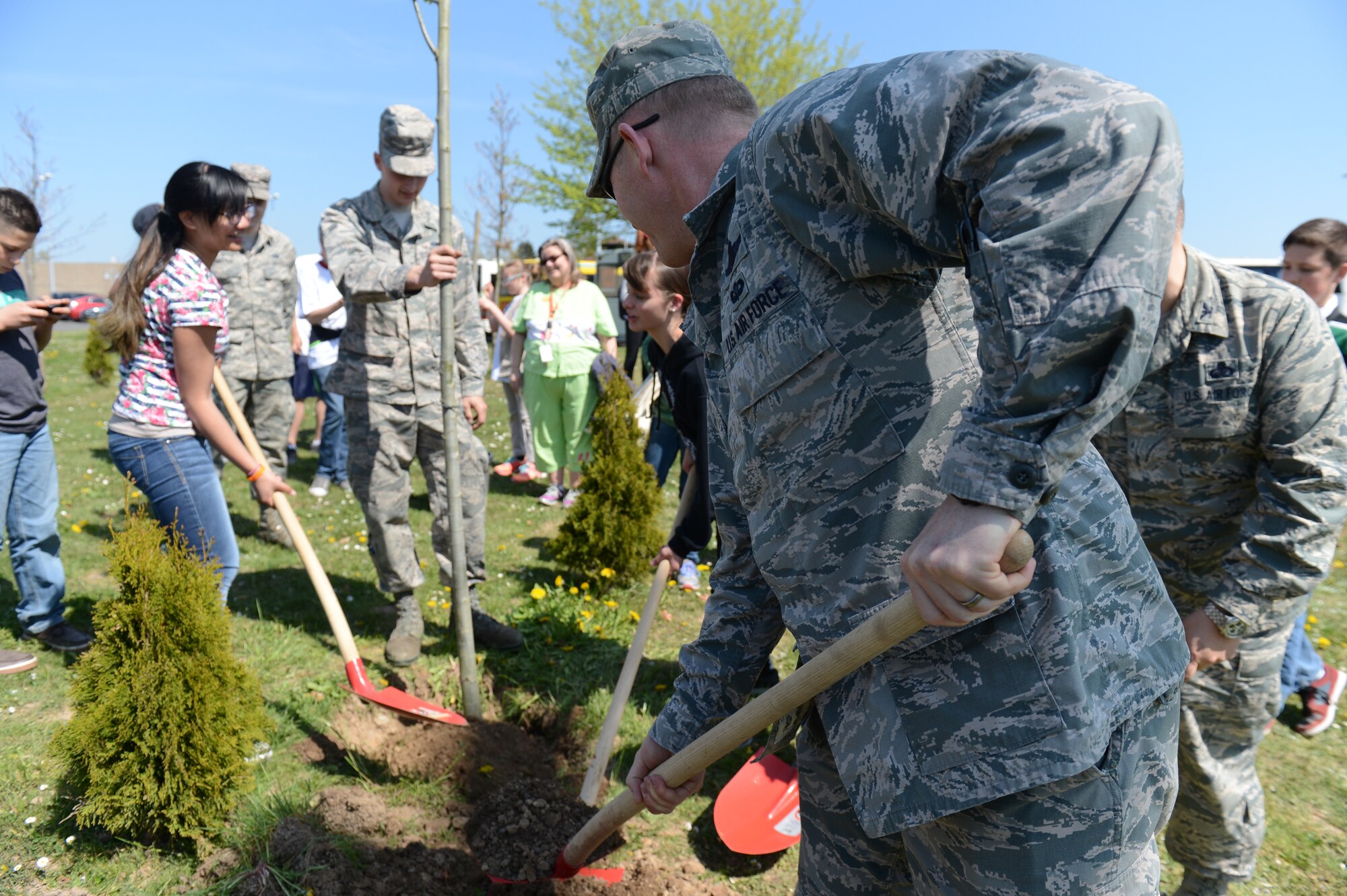 Leadership from the 52nd Fighter Wing, students from Spangdahlem Middle School and local girl scouts took part in the annual Earth Week tree planting at Spangdahlem Air Base, Germany, April 24, 2015. Four trees were planted this year as part of the environmental awareness event. (U.S. Air force photo by Senior Airman Sarah Denewellis/Released)  