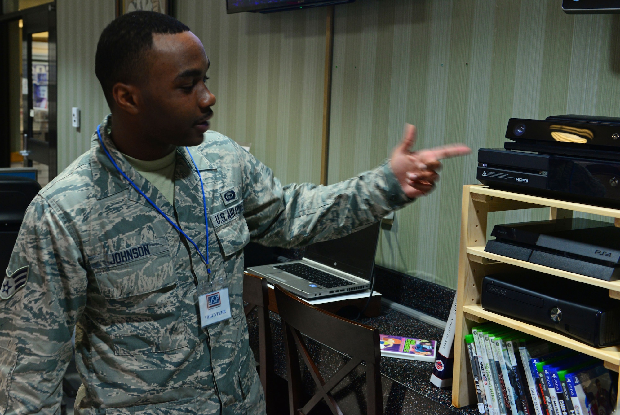 Senior Airman Bradly K. Johnson, 18th Intelligence Squadron, Detachment 2 multi-mission space analyst, points out movies inside the United Services Organization at Osan Air Base Republic of Korea. Johnson was chosen as a Team Osan Spotlight award winner. Individuals who are chosen for this spotlight recognition are distinguished as consistent, superior performers within their squadrons. (U.S. Air Force photo by Staff Sgt. Benjamin Sutton/Released)